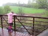 Child viewing water from bridge