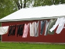 Laundry hanging in front of a red farm building